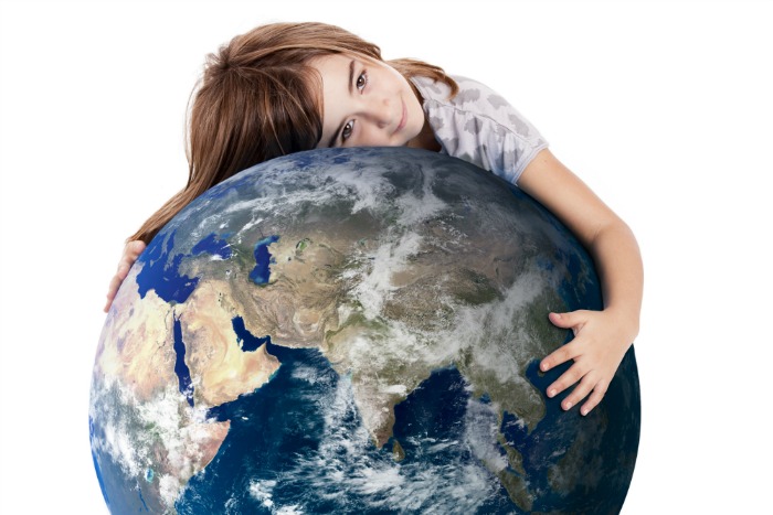 Little girl hugging the planet earth over a white background