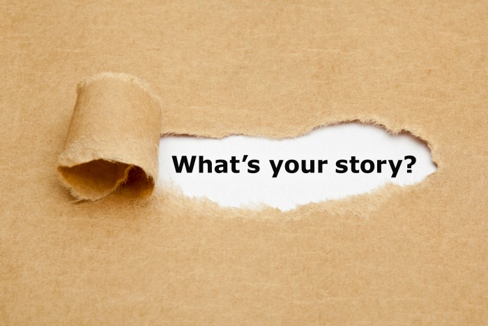 Storytelling and business – The text What’s Your Story appearing behind torn brown paper.