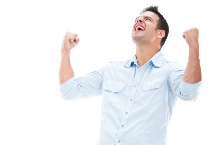Casual man winning and celebrating – isolated over white