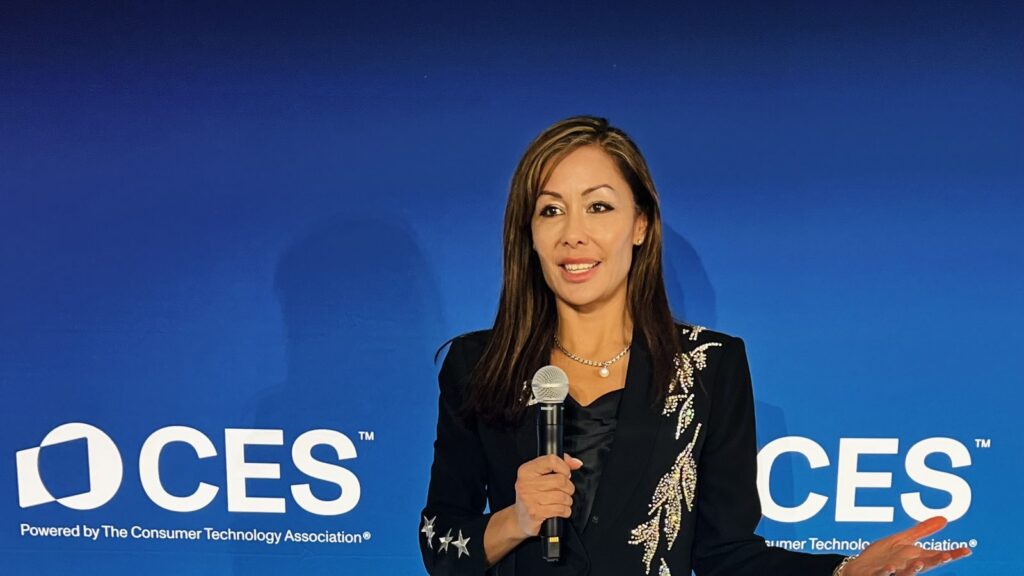 Susan Sly, AI keynote speaker, delivering a keynote on the CES stage
