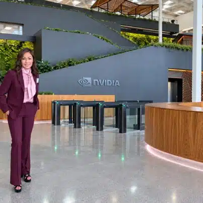 Susan Sly, AI keynote speaker, standing in the lobby of NVIDIA headquarters